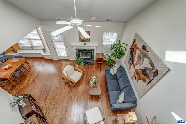 wooden floor living room with furniture and a fireplace