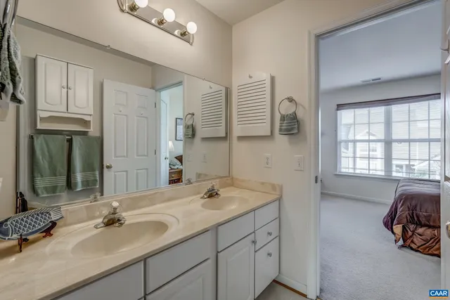 a en suite bathroom with a sink and a mirror
