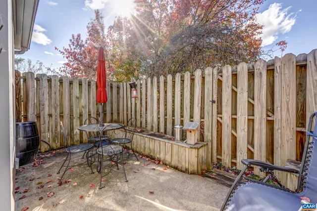 a view of a backyard with wooden fence