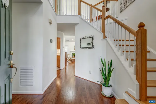 a view of staircase with wooden floor and a potted plant