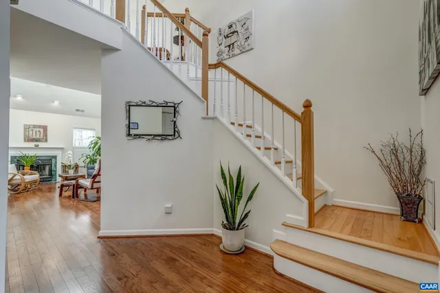 a view of staircase with furniture and a potted plant