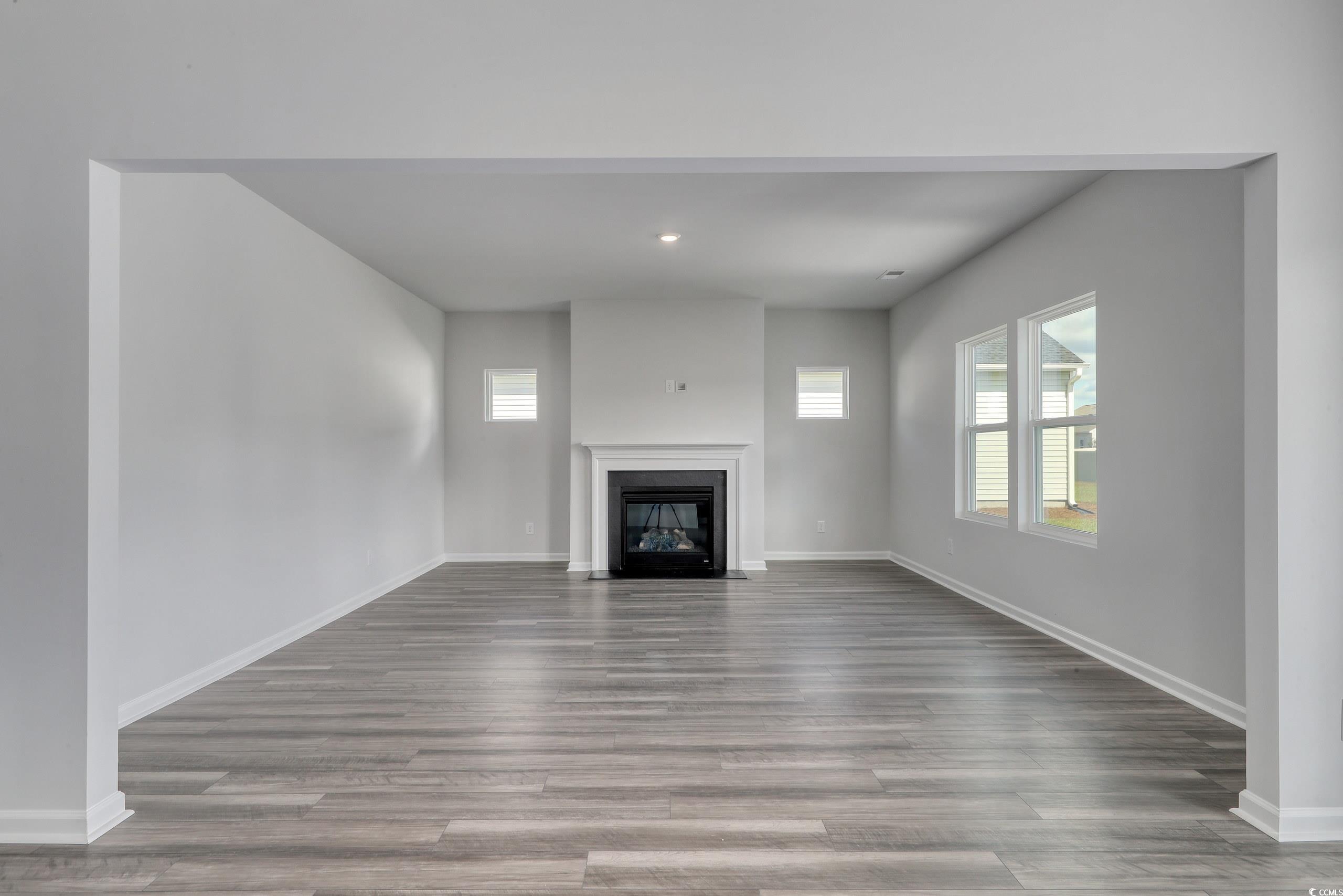 728 St Albans Loop Conway, SC 29526 - Photo 3 of 19 Unfurnished living room with wood-type flooring
