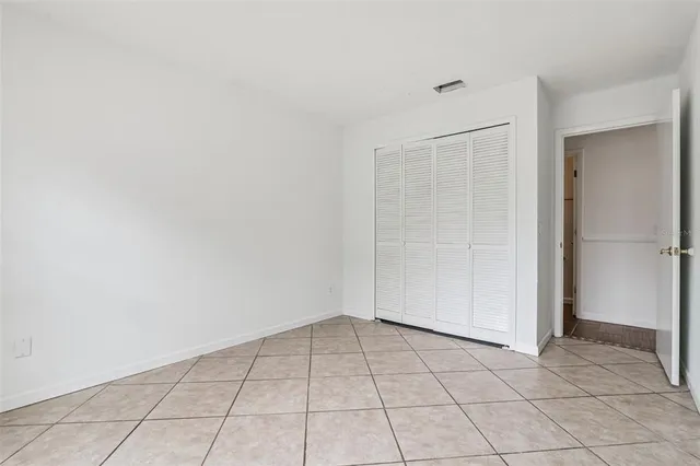 a backyard of a house with plants and tree