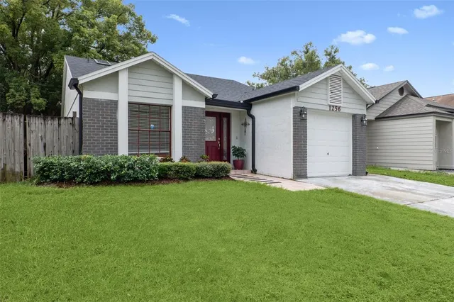 a view of a house with a yard and garage
