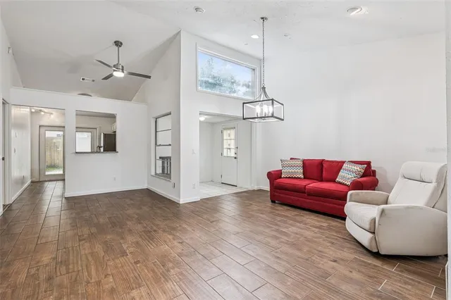 a living room with furniture and wooden floor