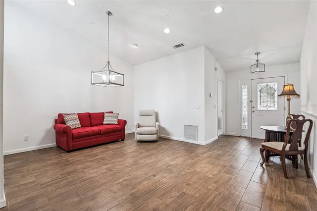 a living room with furniture and wooden floor