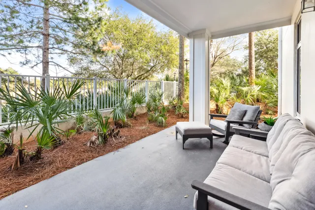 a living room with furniture and a floor to ceiling window