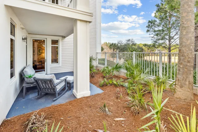 a balcony with furniture and a potted plant