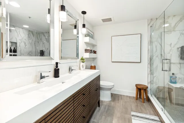a bathroom with a sink double vanity and a toilet