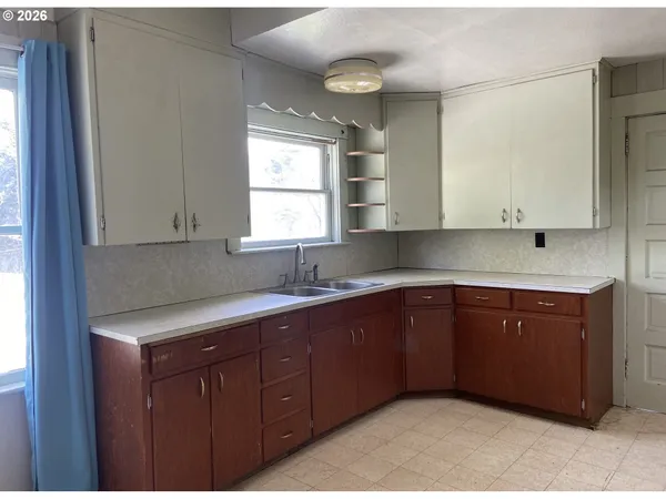 a kitchen with stainless steel appliances granite countertop cabinets and window