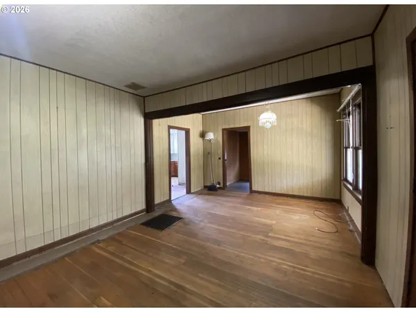 a view of a livingroom with wooden floor and natural light