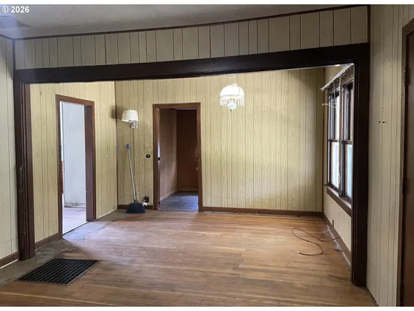 a view of a room with wooden floor and windows