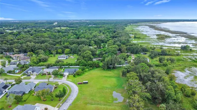 an aerial view of a houses with a yard