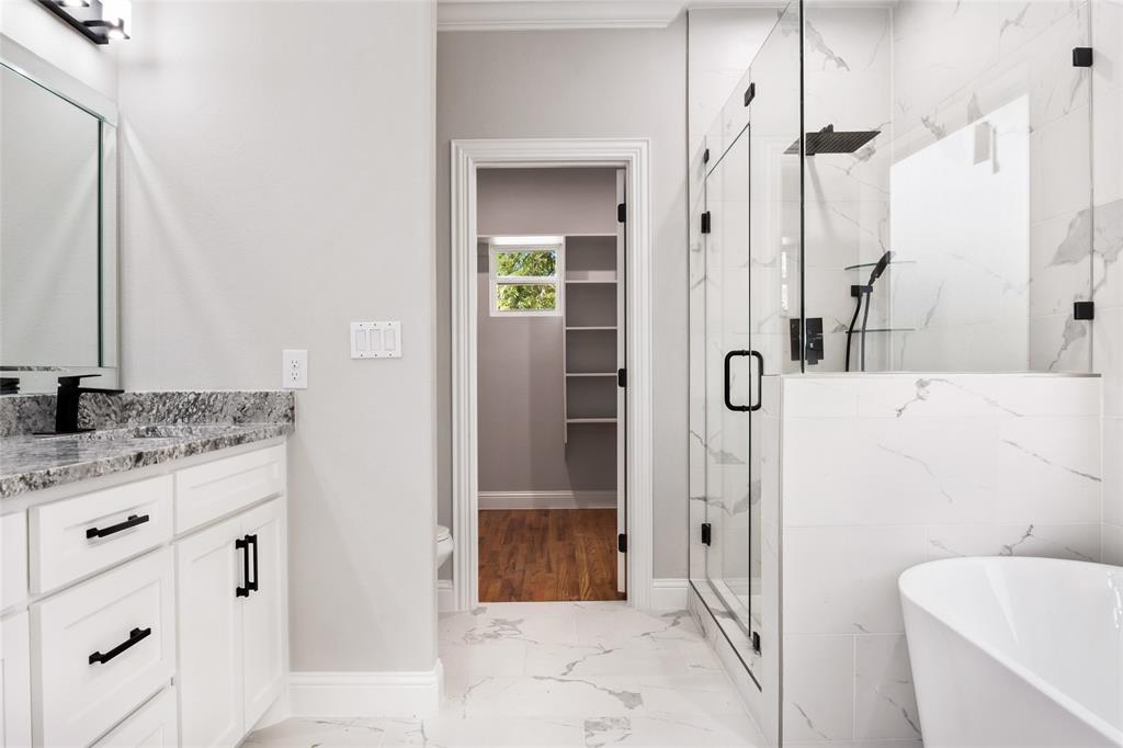 3102 Chicago Street Dallas, TX 75212 - Photo 11 of 20 a bathroom with a granite countertop sink a mirror and a shower