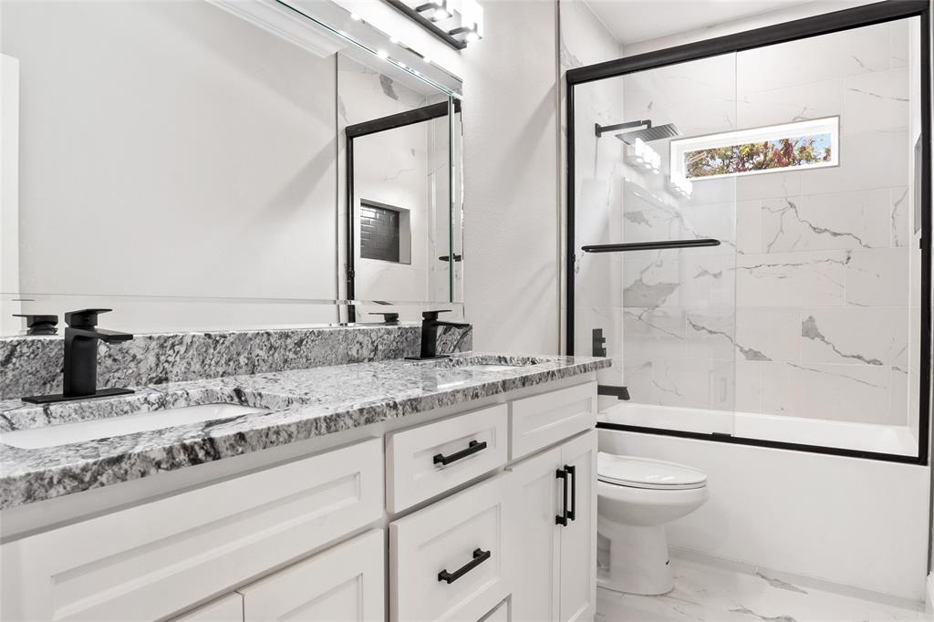 3102 Chicago Street Dallas, TX 75212 - Photo 14 of 20 a bathroom with a granite countertop sink a toilet and a mirror