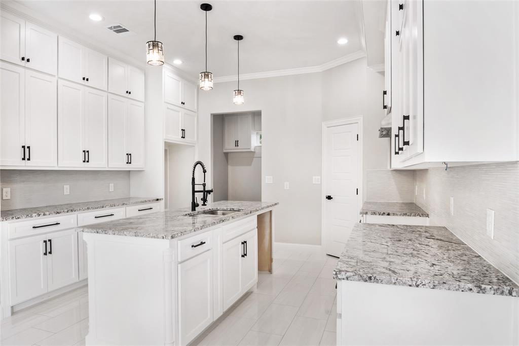 3102 Chicago Street Dallas, TX 75212 - Photo 8 of 20 a kitchen with kitchen island granite countertop a sink a counter top space and cabinets