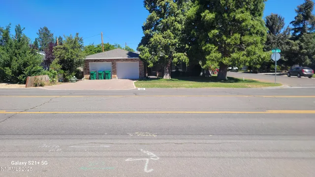 a view of a house with a yard and a trees