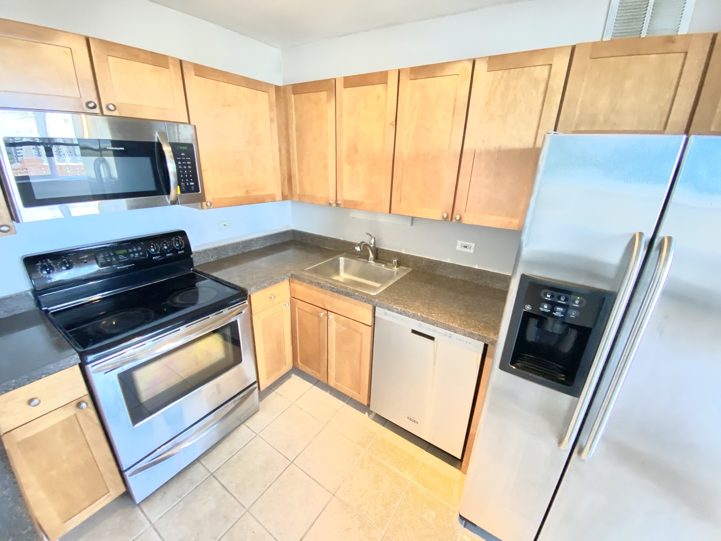 655 West Irving Park Road, Unit 2112 Chicago, IL 60613 - Photo 11 of 49 a kitchen with stainless steel appliances a stove microwave and sink