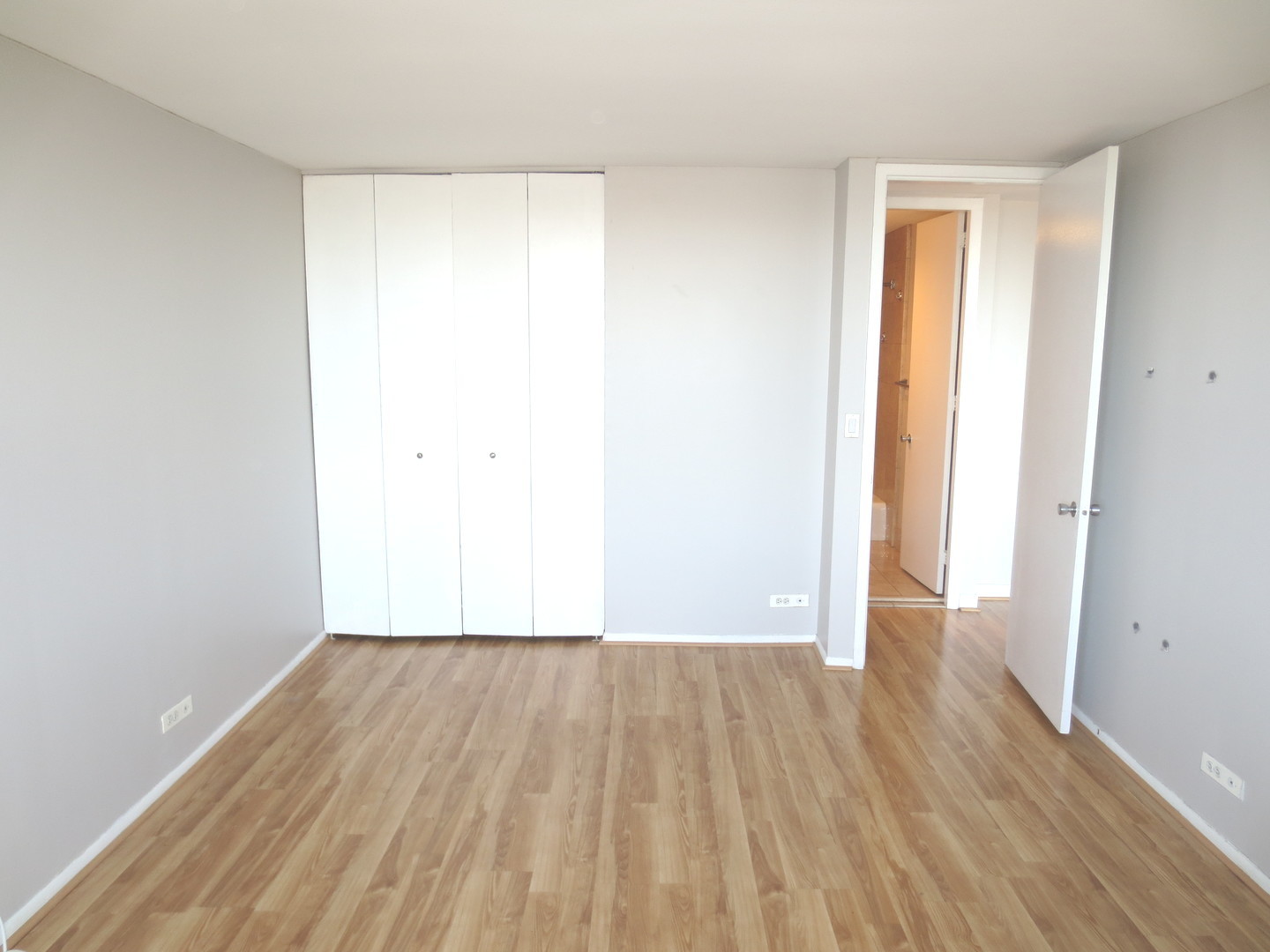 655 West Irving Park Road, Unit 2112 Chicago, IL 60613 - Photo 12 of 49 a view of a room with wooden floor and a window