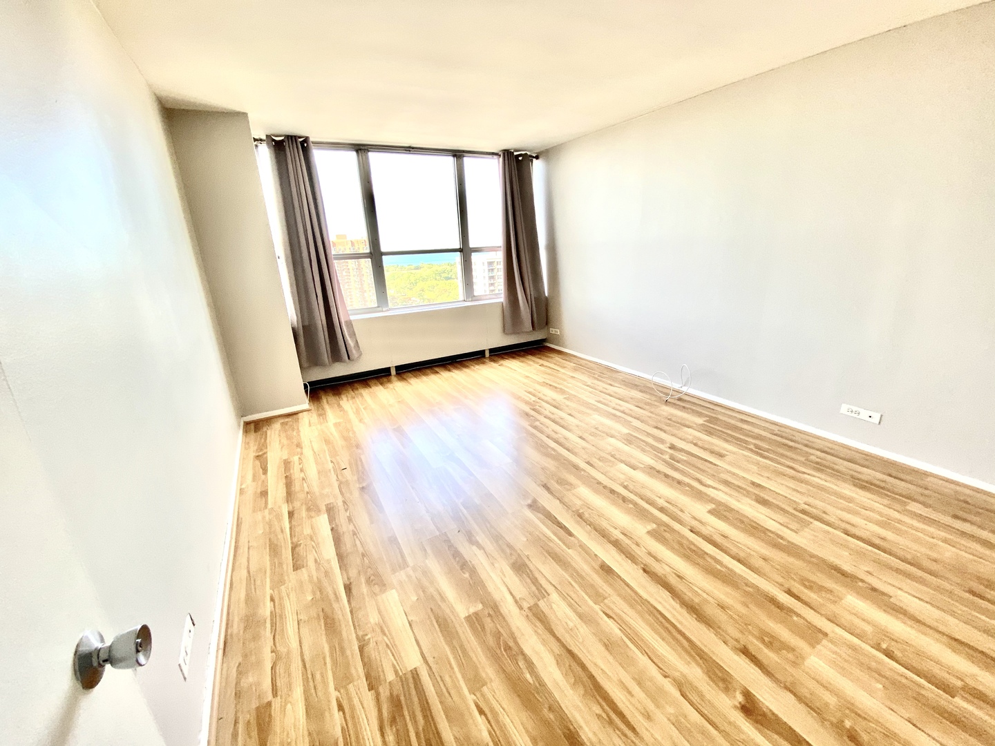 655 West Irving Park Road, Unit 2112 Chicago, IL 60613 - Photo 13 of 49 an empty room with wooden floor and windows