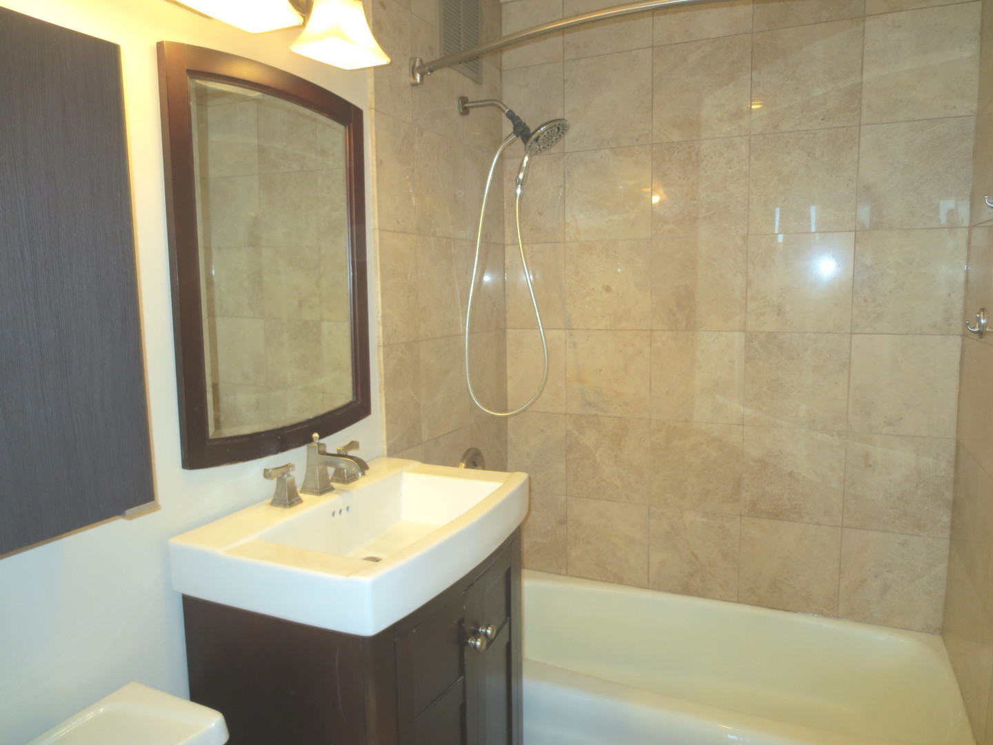 655 West Irving Park Road, Unit 2112 Chicago, IL 60613 - Photo 16 of 49 a bathroom with a sink toilet tub and shower