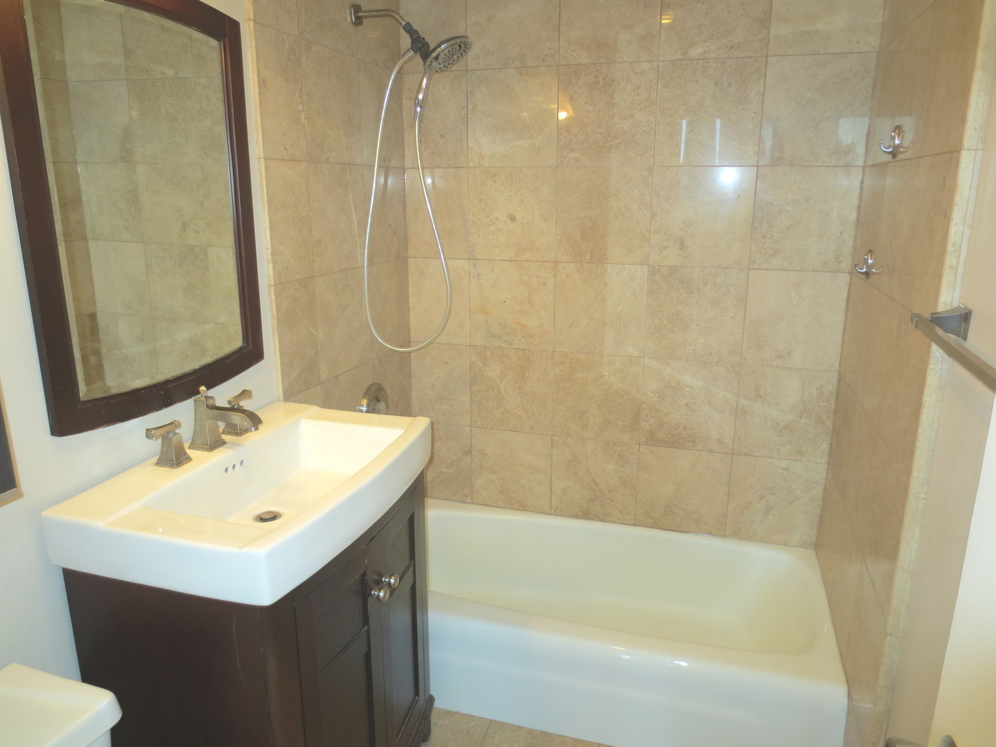 655 West Irving Park Road, Unit 2112 Chicago, IL 60613 - Photo 17 of 49 a bathroom with a sink mirror toilet and bathtub