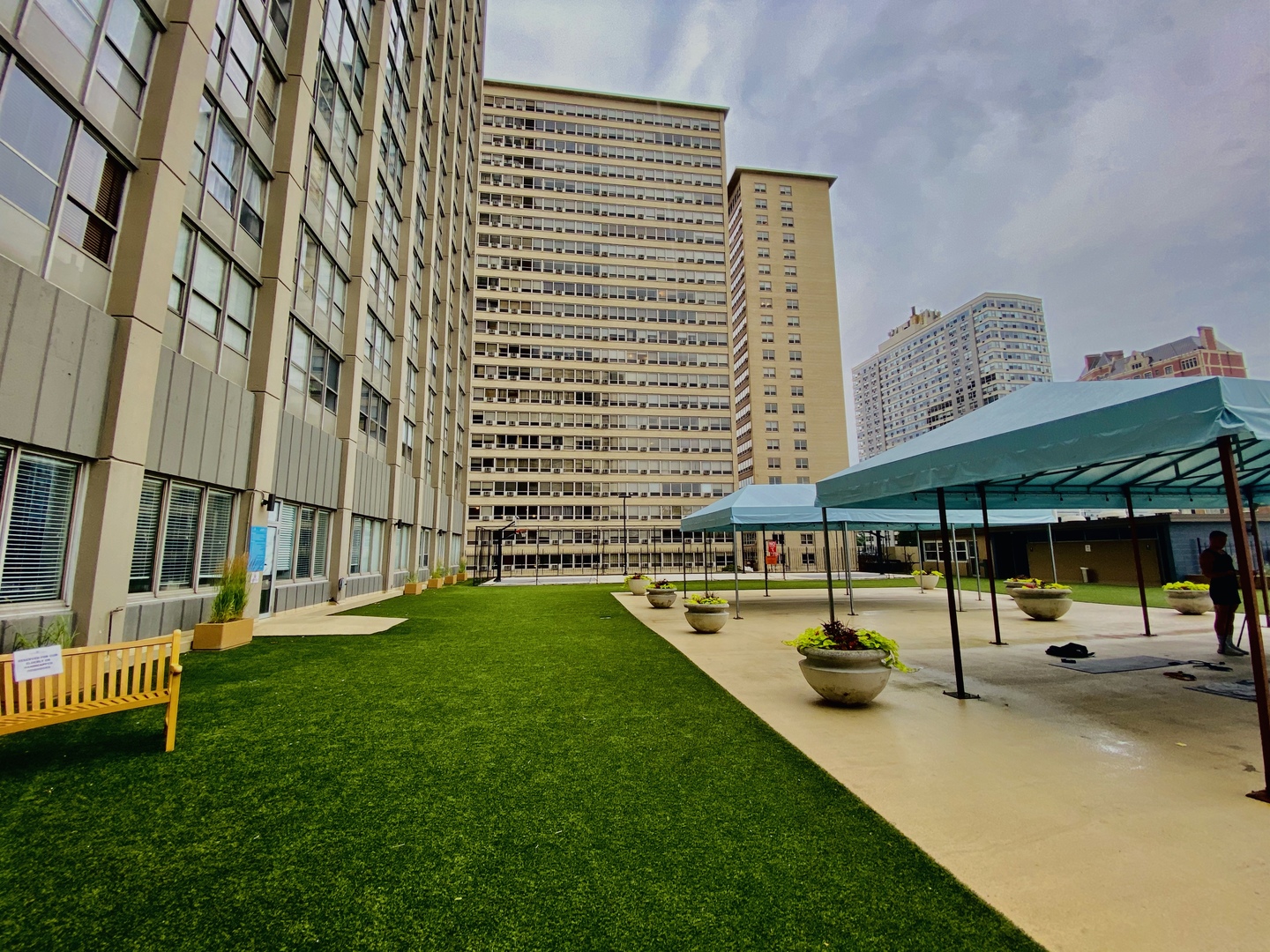 655 West Irving Park Road, Unit 2112 Chicago, IL 60613 - Photo 24 of 49 a view of swimming pool with lawn chairs and wooden fence
