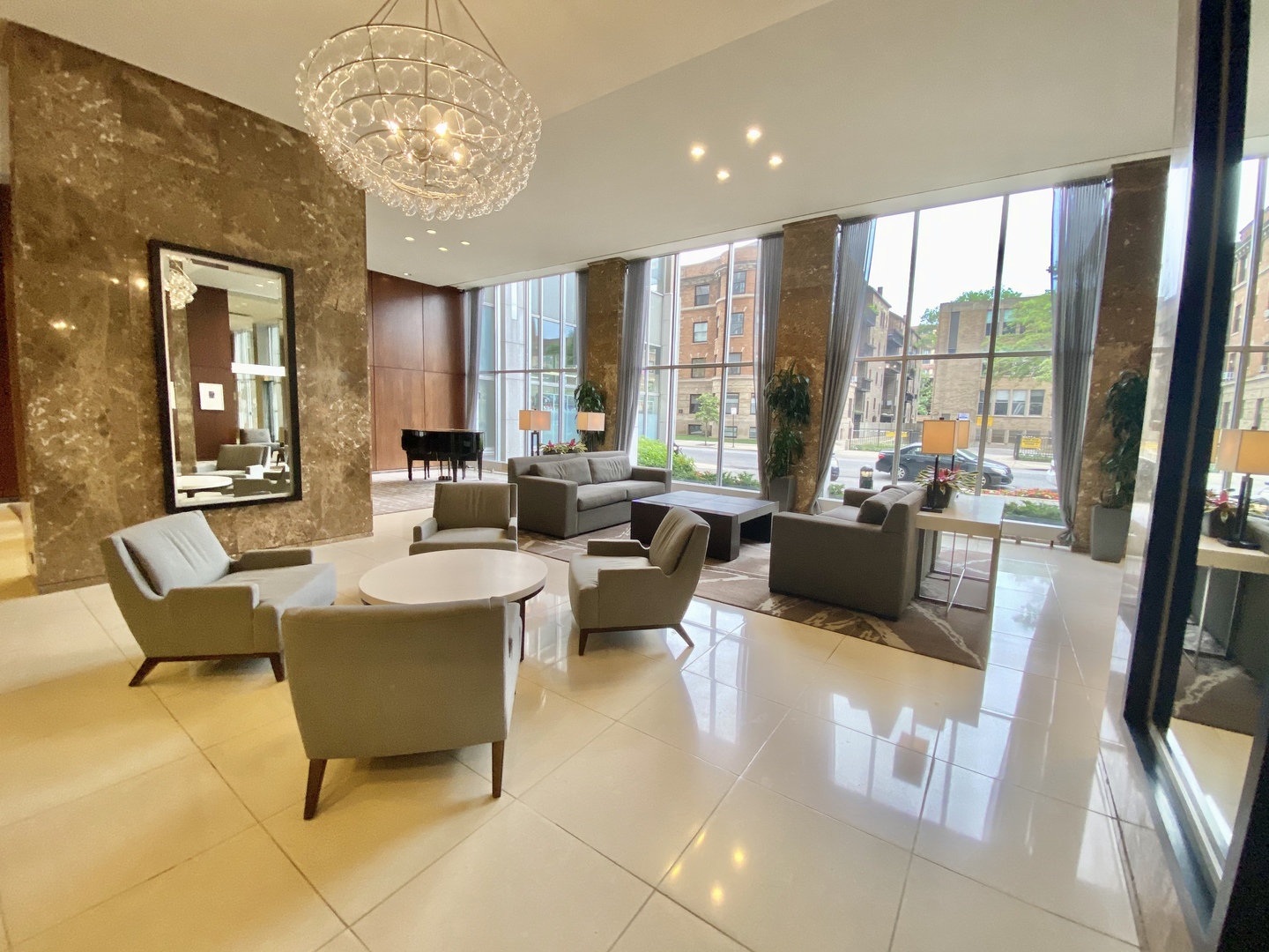 655 West Irving Park Road, Unit 2112 Chicago, IL 60613 - Photo 28 of 49 a living room with furniture and a chandelier