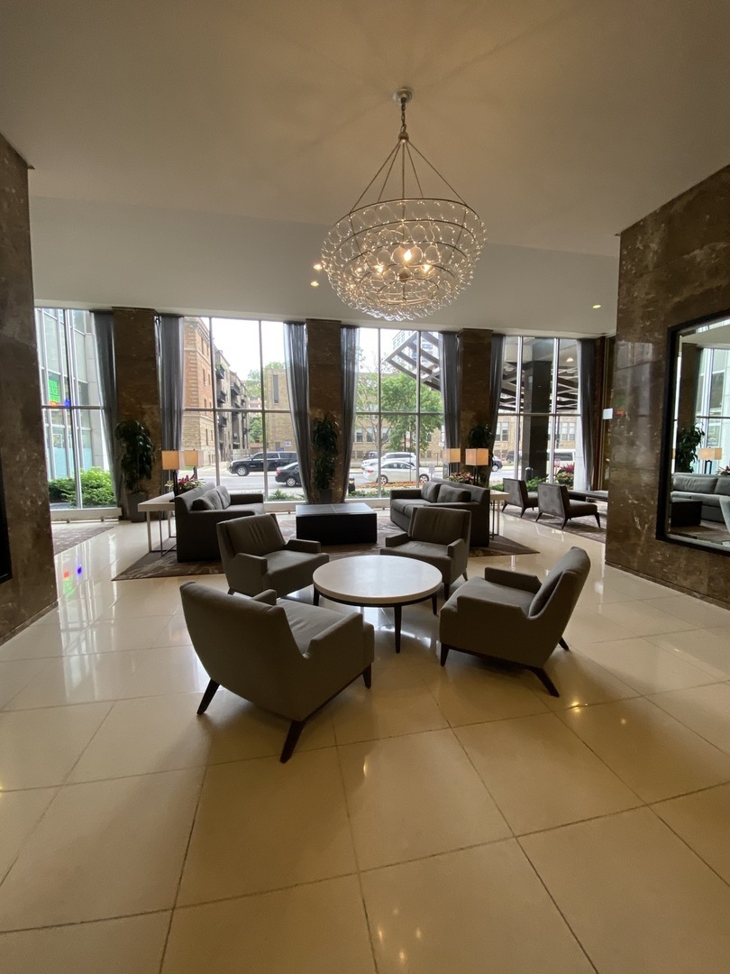 655 West Irving Park Road, Unit 2112 Chicago, IL 60613 - Photo 29 of 49 a living room with fireplace furniture and a large window
