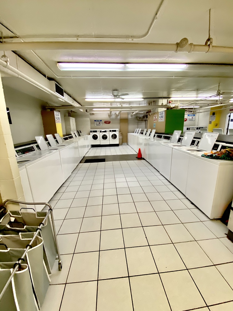 655 West Irving Park Road, Unit 2112 Chicago, IL 60613 - Photo 33 of 49 a kitchen with a refrigerator and white cabinets