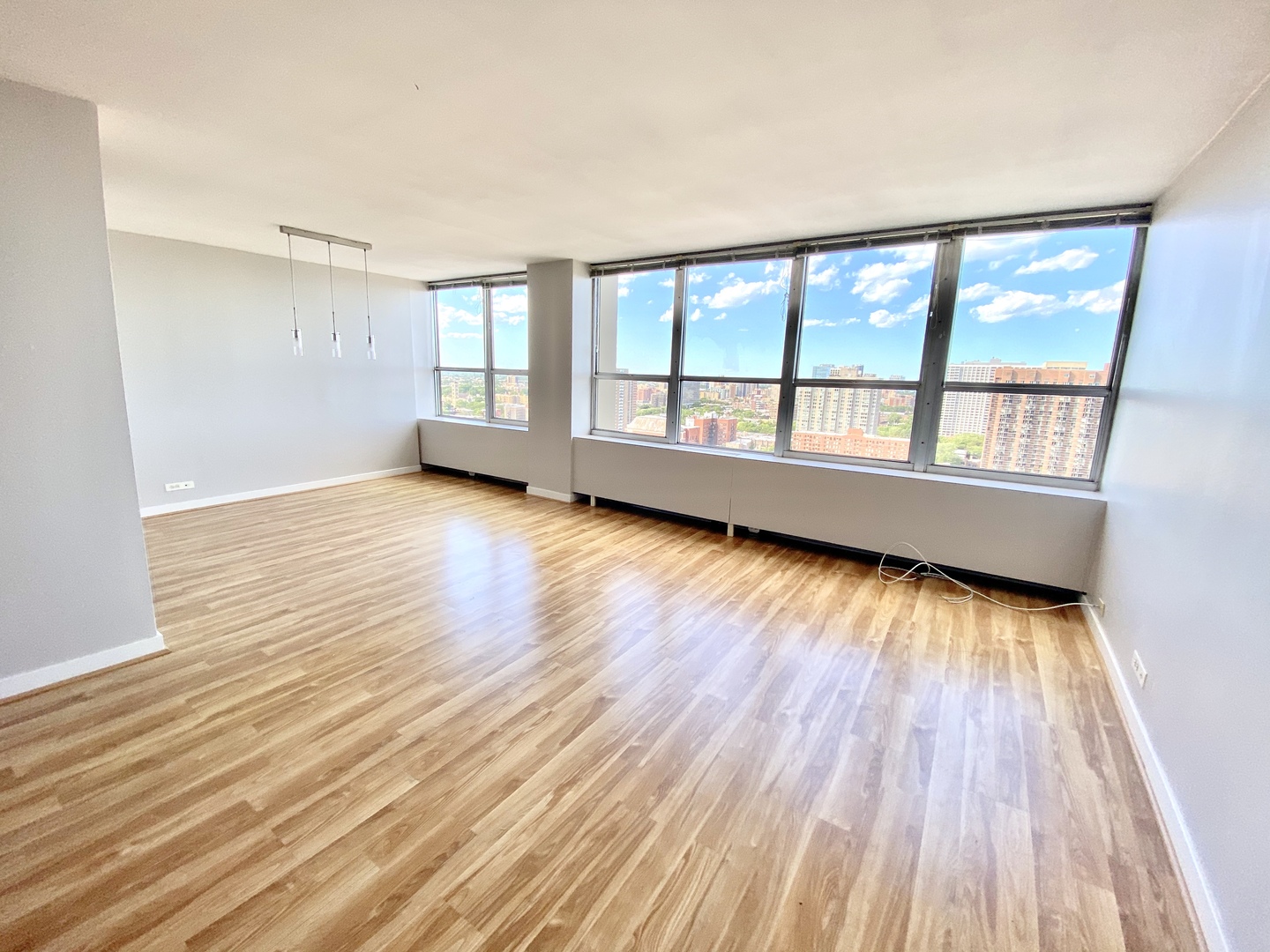 655 West Irving Park Road, Unit 2112 Chicago, IL 60613 - Photo 6 of 49 wooden floor in an empty room with a window