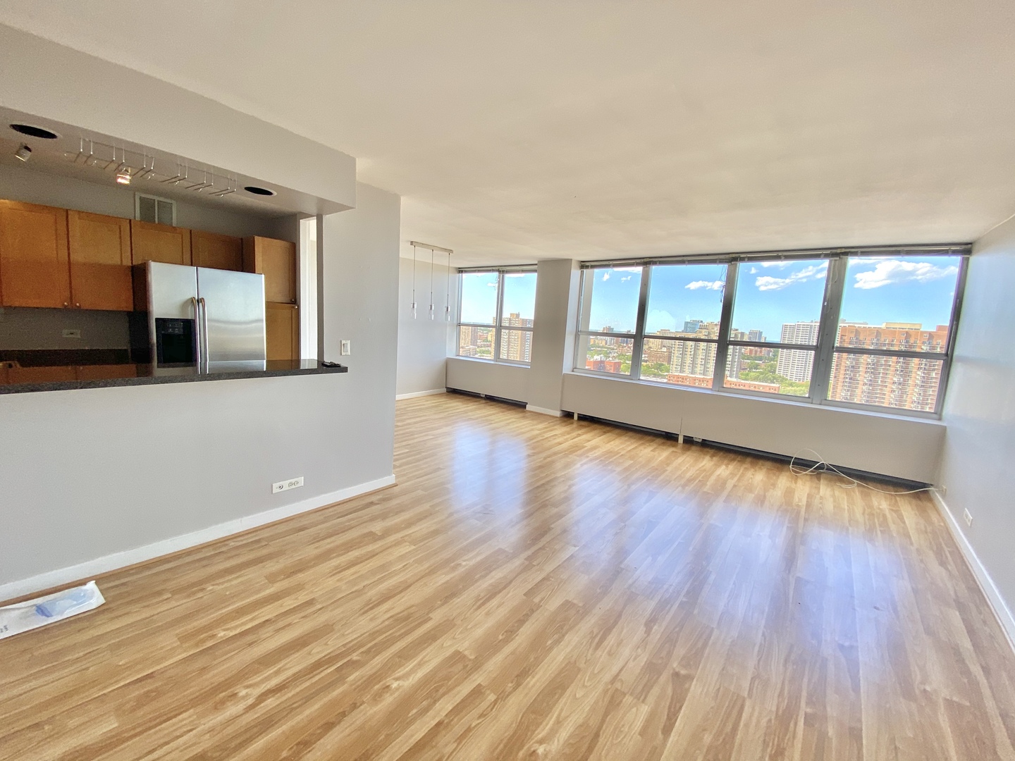 655 West Irving Park Road, Unit 2112 Chicago, IL 60613 - Photo 7 of 49 a view of an empty room with wooden floor and a window