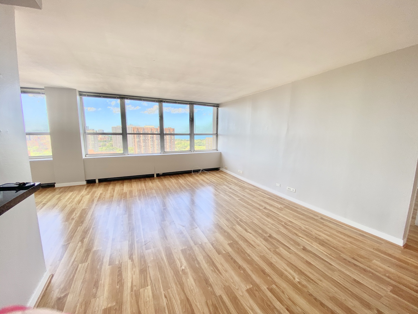 655 West Irving Park Road, Unit 2112 Chicago, IL 60613 - Photo 8 of 49 wooden floor in an empty room with a window