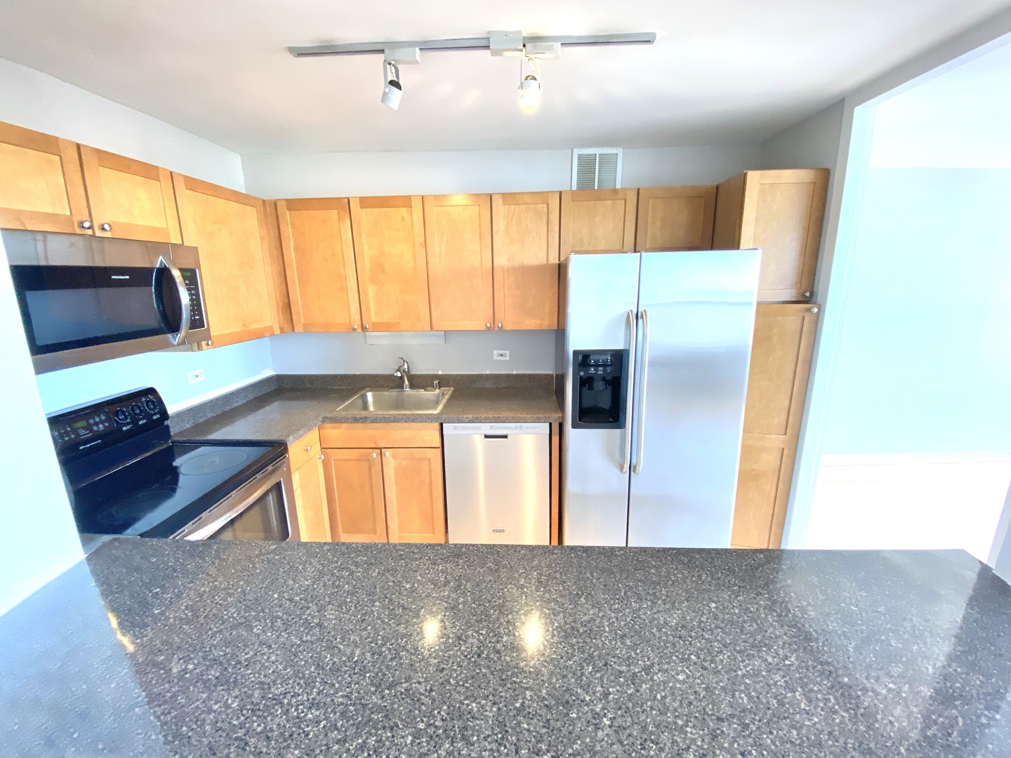 655 West Irving Park Road, Unit 2112 Chicago, IL 60613 - Photo 10 of 49 a kitchen with stainless steel appliances granite countertop a refrigerator and a sink