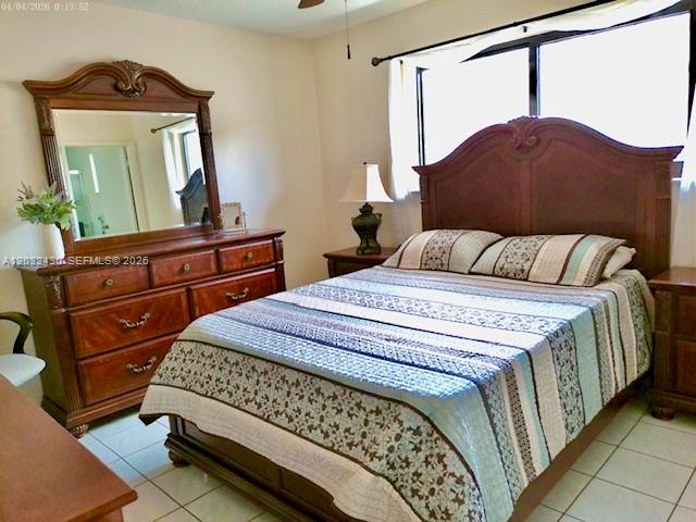 6527 West 22nd Lane Hialeah, FL 33016 - Photo 10 of 18 a bedroom with a bed window and mirror on dresser