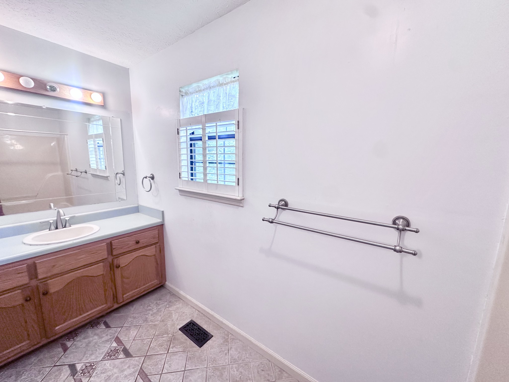 141 South Palmers Chapel Road White House, TN 37188 - Photo 27 of 33 a bathroom with a granite countertop sink a mirror and a bathtub