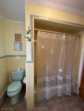 a bathroom with a toilet and shower