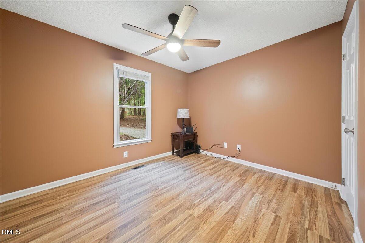 5216 Relay Way Raleigh, NC 27603 - Photo 12 of 27 a view of empty room with wooden floor and fan
