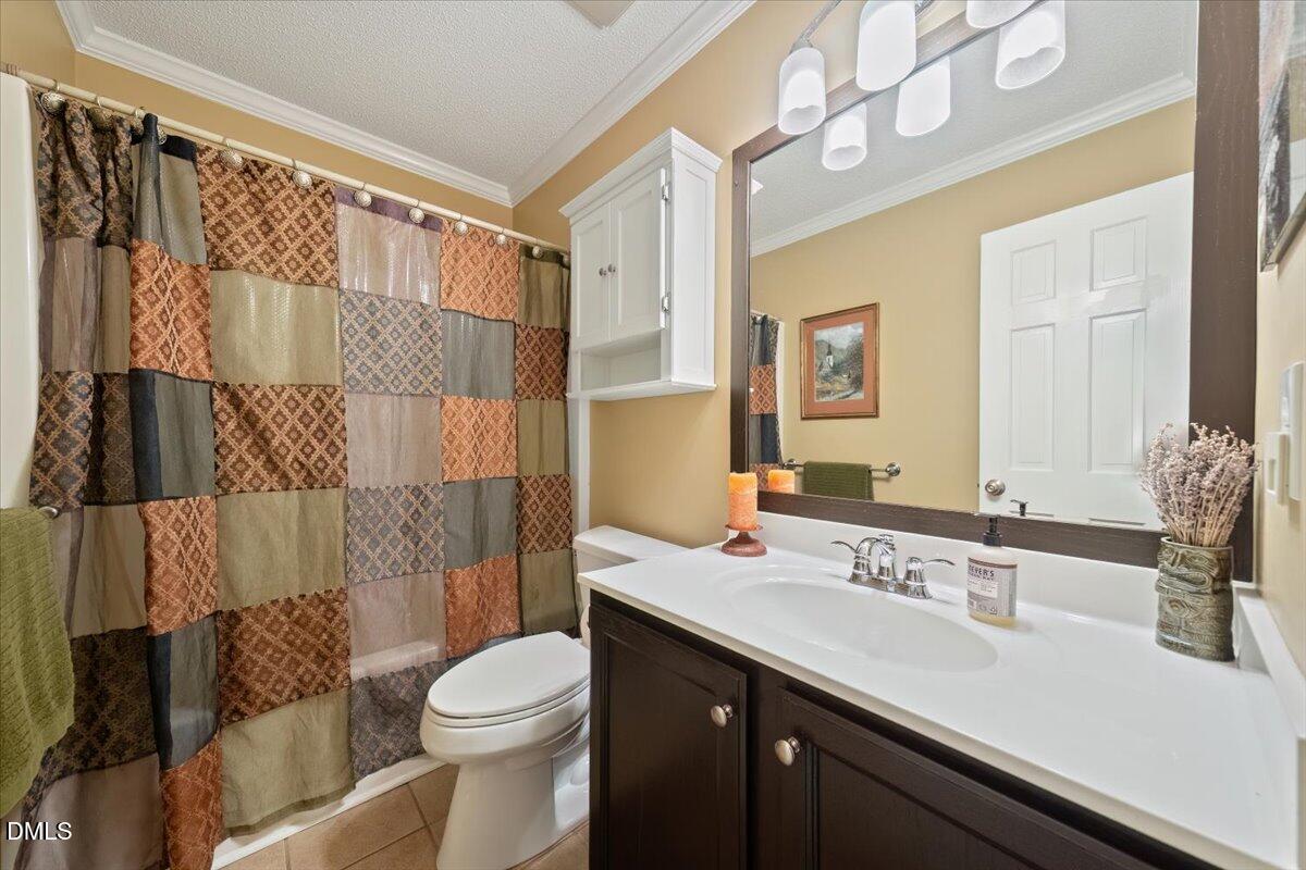 5216 Relay Way Raleigh, NC 27603 - Photo 14 of 27 a bathroom with a sink a toilet and shower