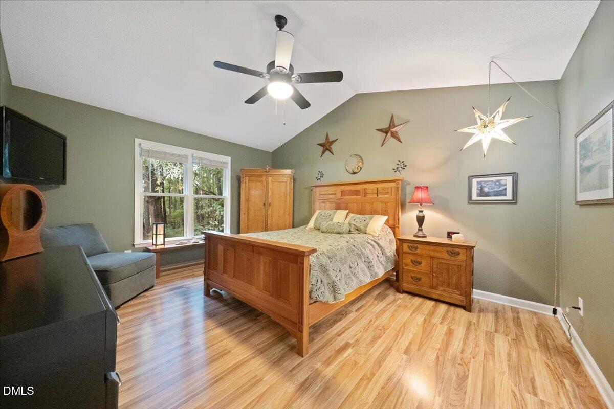 5216 Relay Way Raleigh, NC 27603 - Photo 16 of 27 a bedroom with a bed and wooden floor