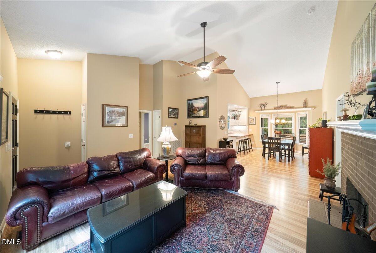5216 Relay Way Raleigh, NC 27603 - Photo 5 of 27 a living room with furniture a dining table and a chandelier