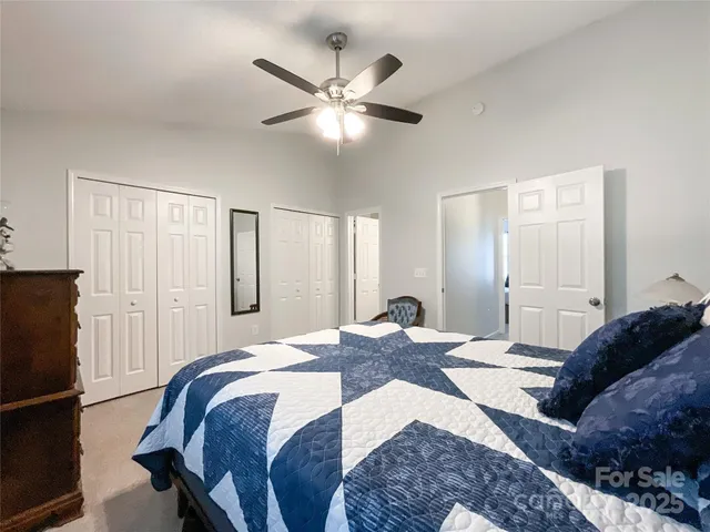 a bedroom with a bed and a ceiling fan