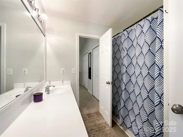 a en suite bathroom with a sink and a mirror