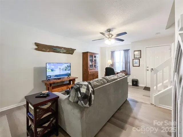 a living room with furniture and a chandelier