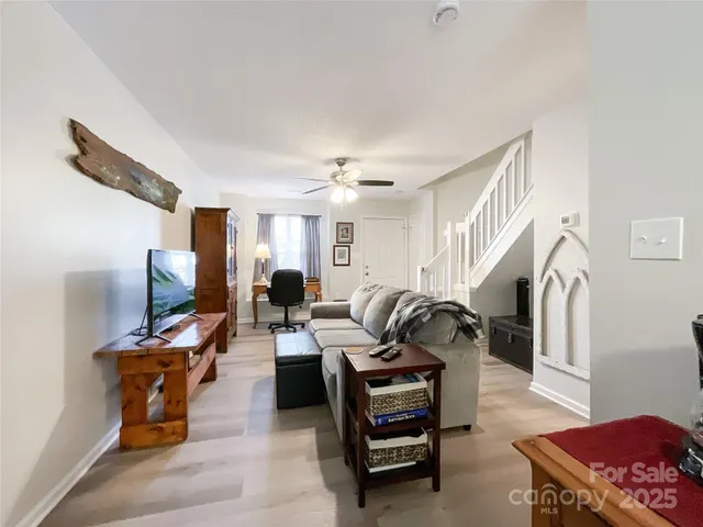 a living room with furniture and a mirror