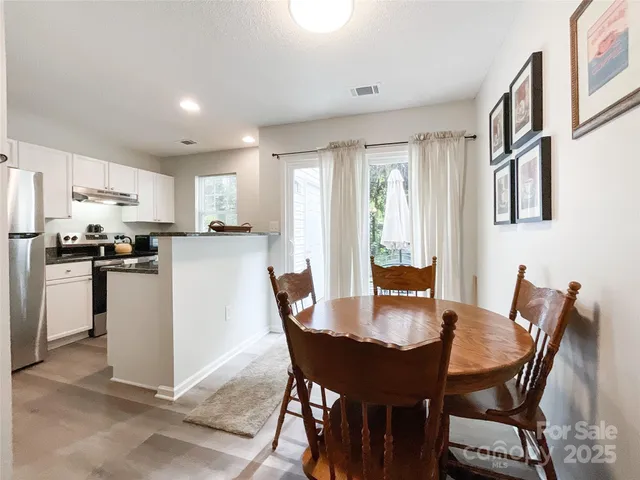 a dining room with furniture and window