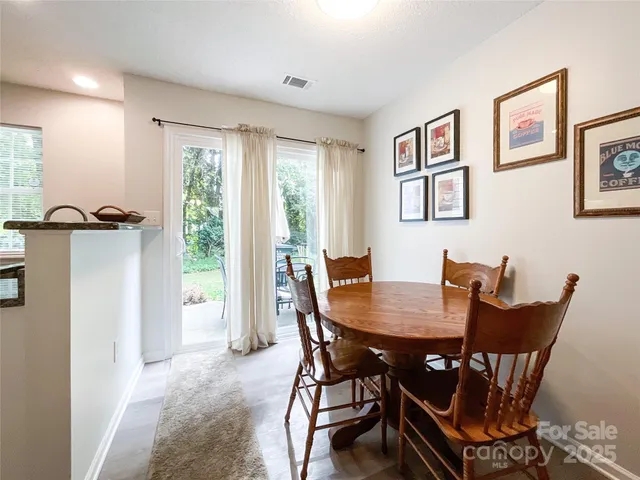 a view of a dining room with furniture and a window