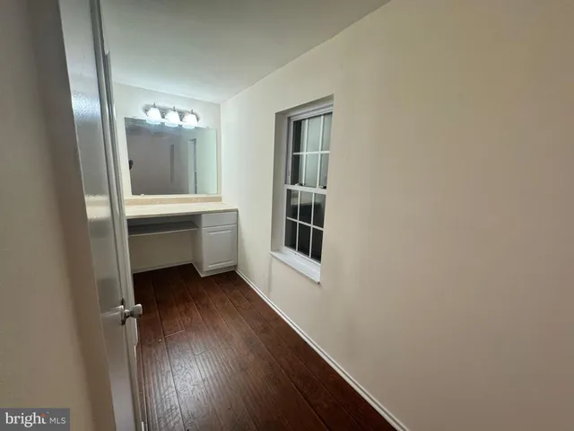 a room with a bench and a window