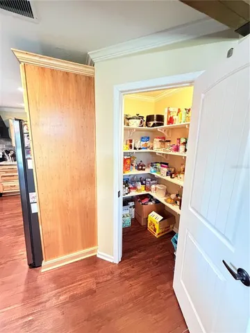 a view of a hardwood floor and a window