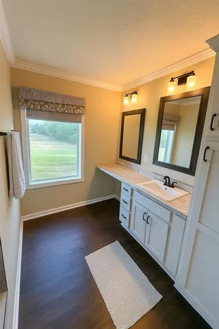a bathroom with a double vanity sink and mirror